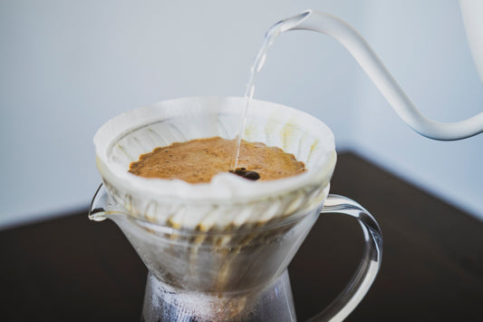 Pouring water through a Hario V60 paper filter