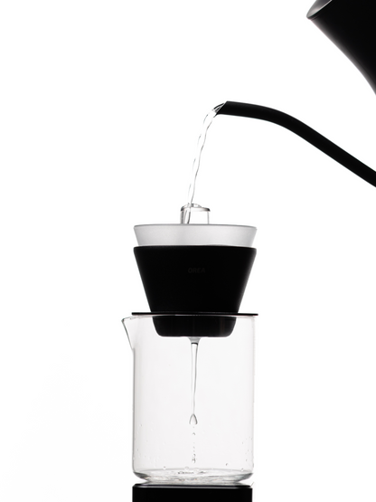 Pouring water through the Orea Neo Negotiator to wet the filter