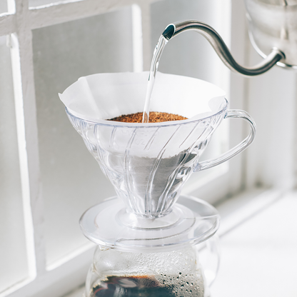 Pour-over brewing through a clear Hario V60 02 dripper